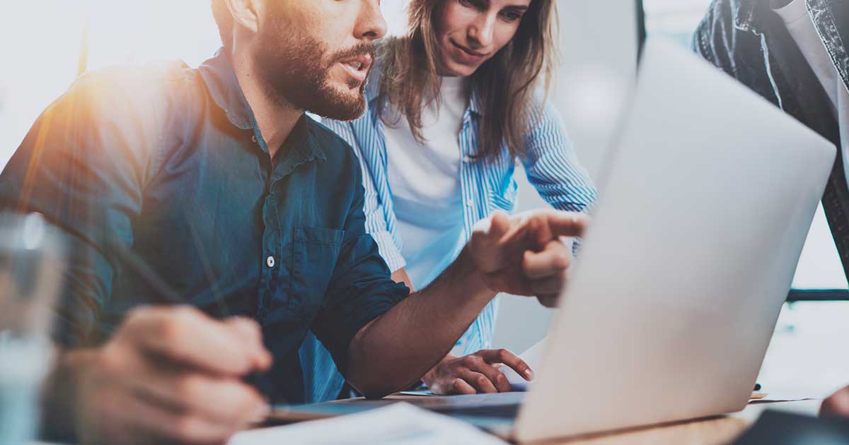 people looking at laptop