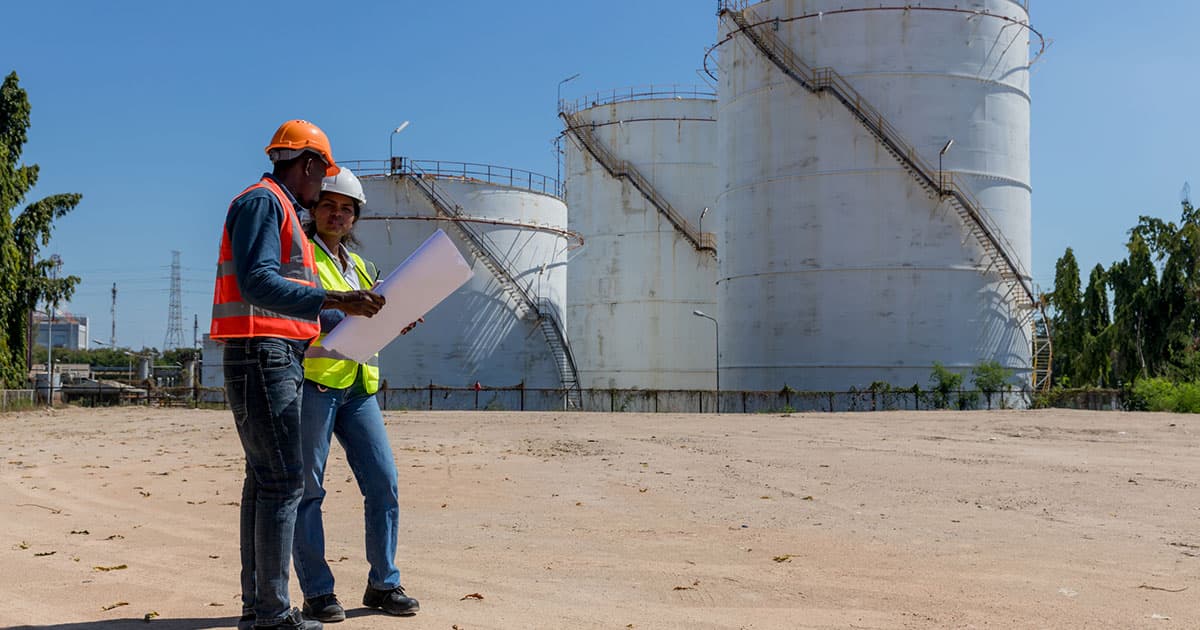 people standing on dirt road
