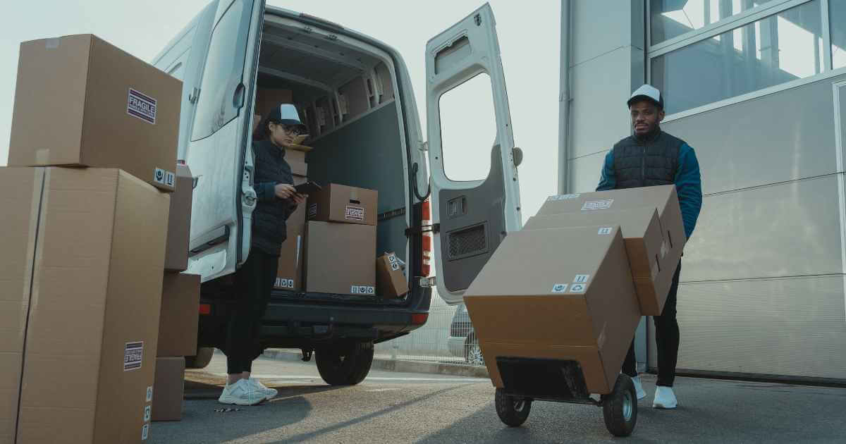 people loading van with boxes