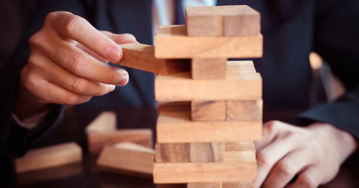 resolutions-blog-010225-image2 hand playing jenga